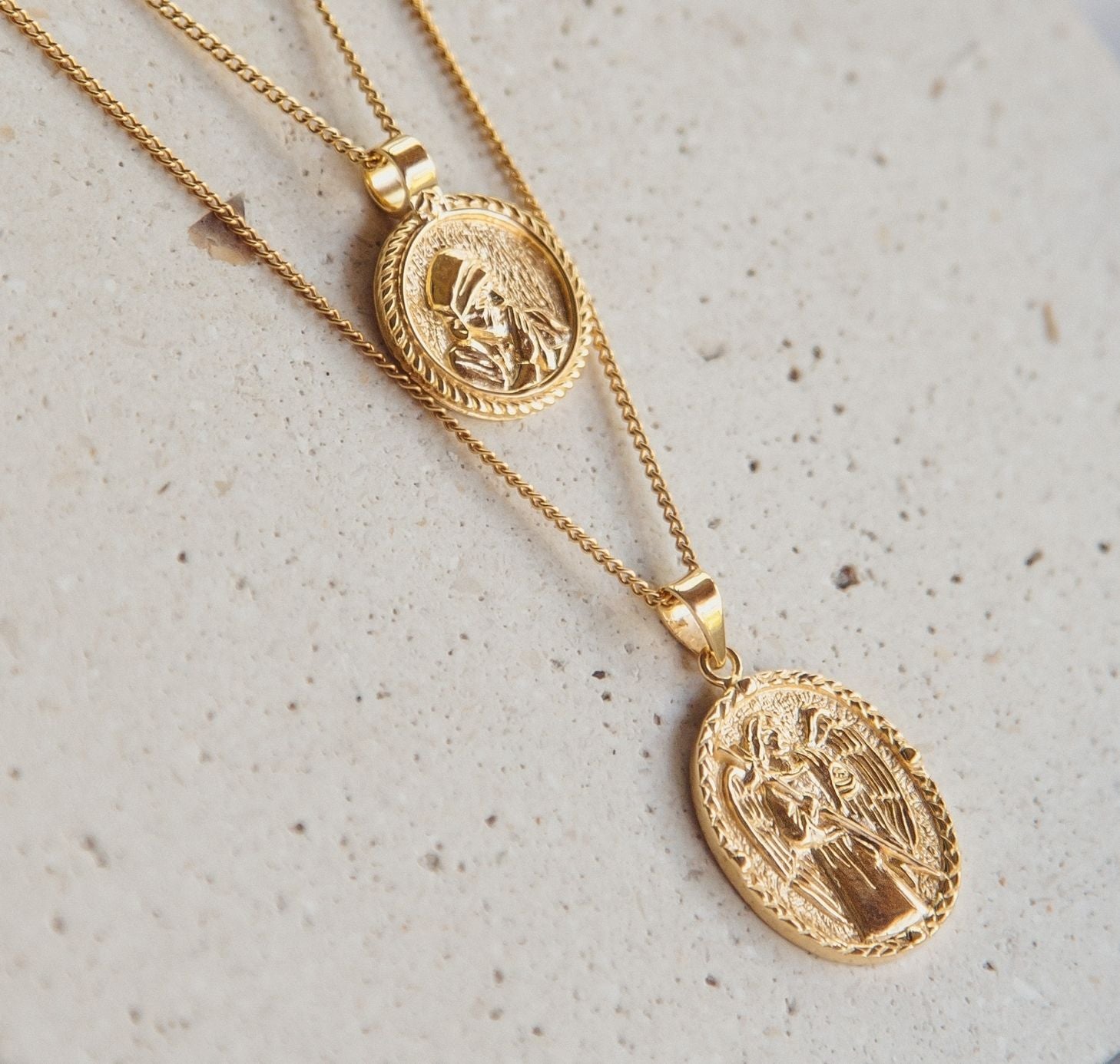 two necklaces gold flat lay in a stone
