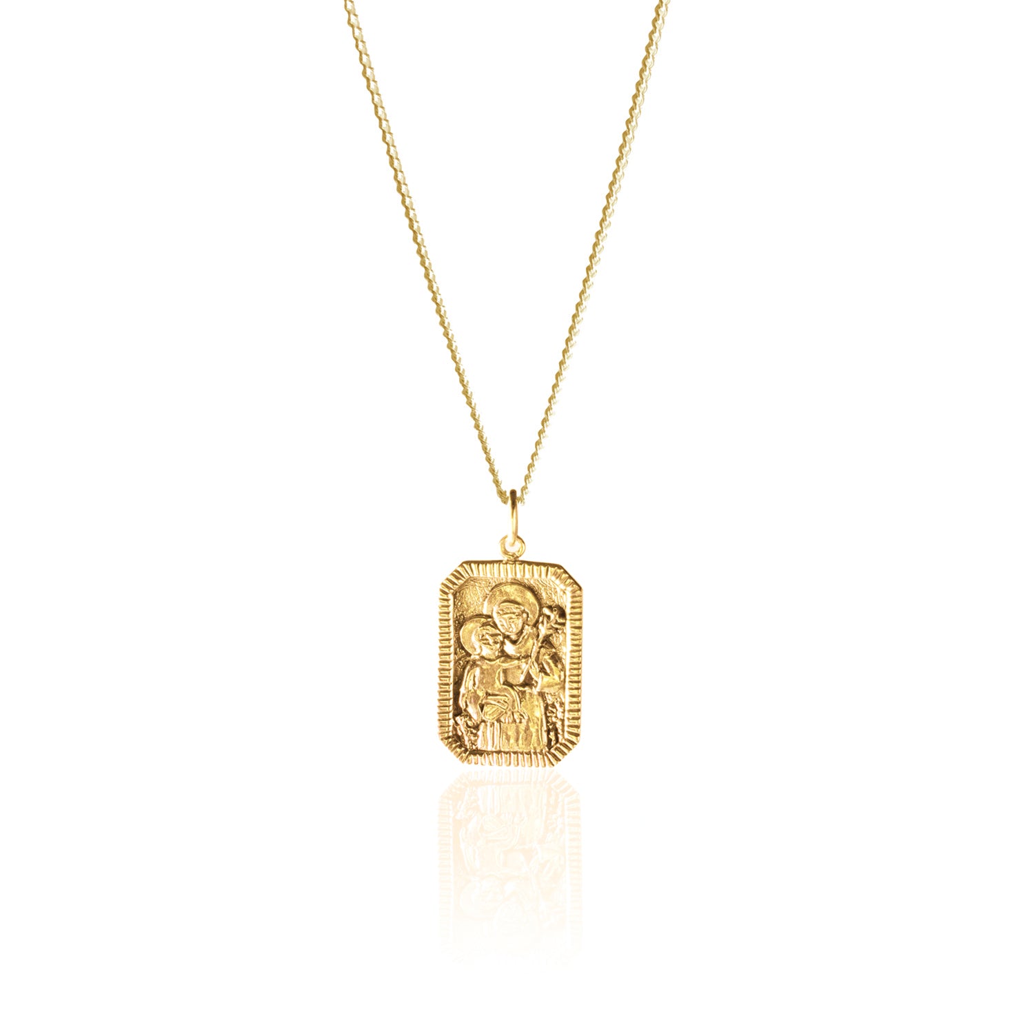 A gold necklace with a rectangular pendant featuring a raised religious figure design, displayed against a white background.