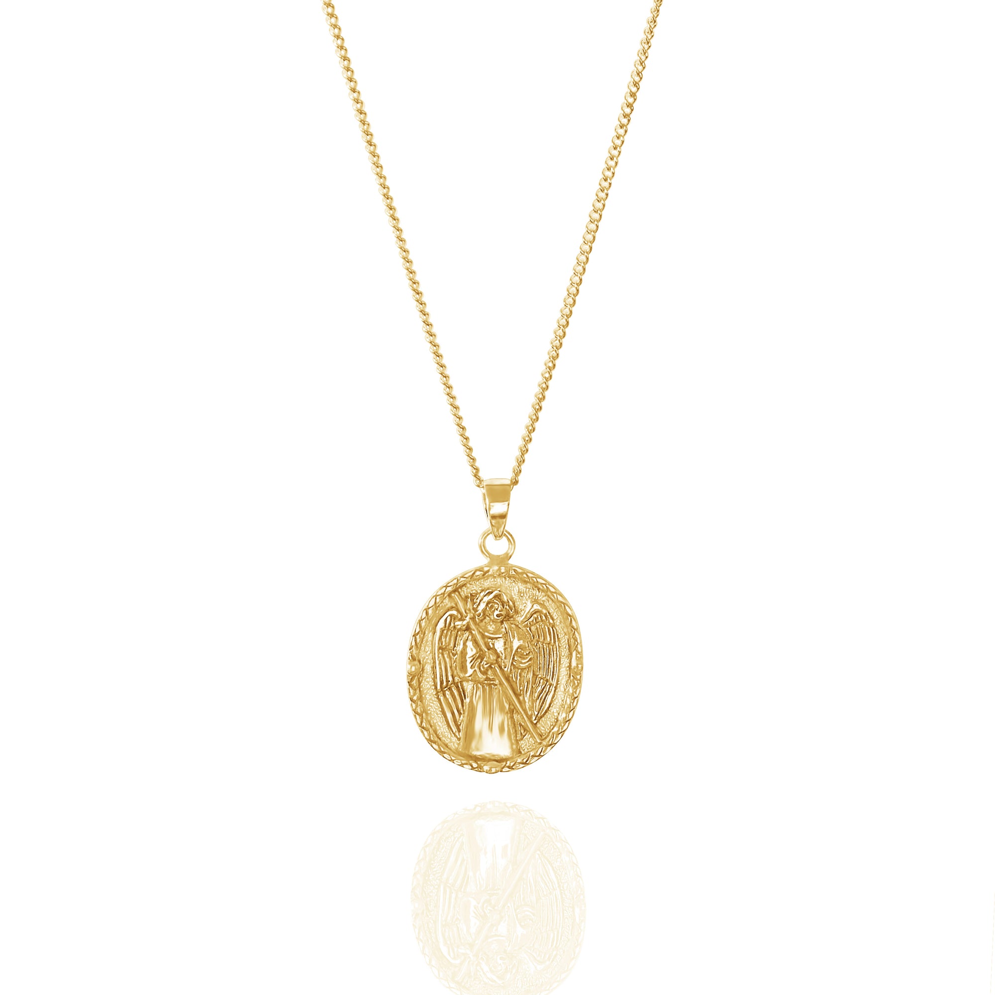 A gold necklace with an oval pendant featuring a raised religious figure design, displayed against a white background.